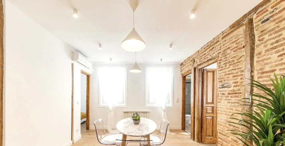 Salón comedor con ladrillo visto y suelo de madera